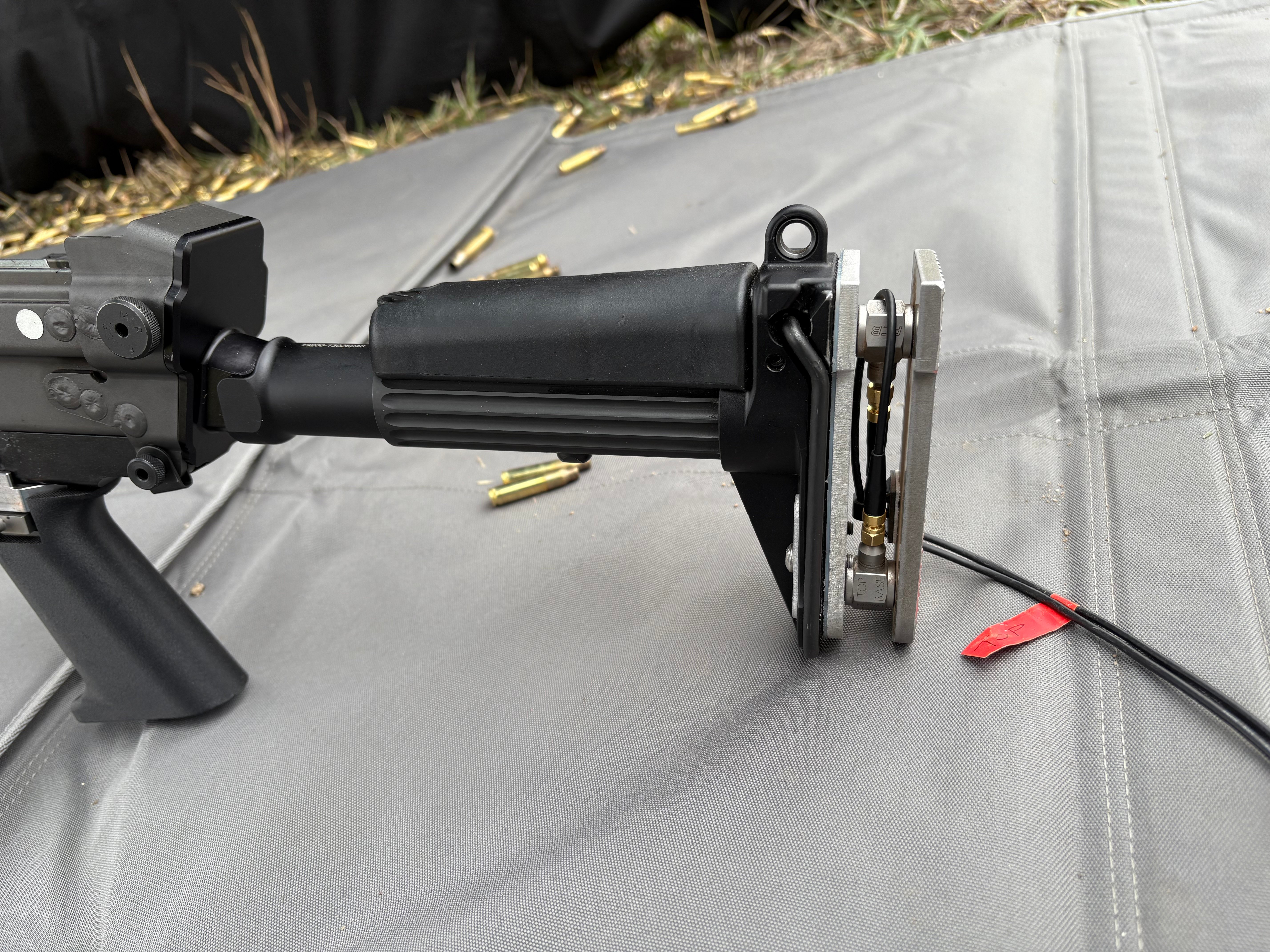 Instrumented firearm stock with two IEPE/ICP force sensors to measure felt recoil in a shooter.